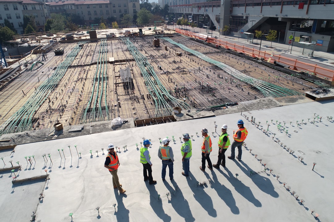 Home seven-construction-workers-standing-on-white-field-x-ghf9ljrvg